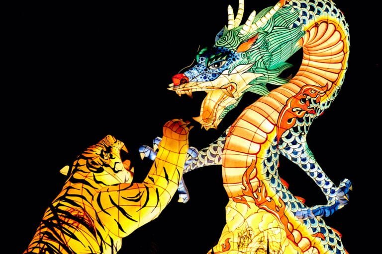 Dragon rising above a tiger representing the advantages of doing business in South Korea.