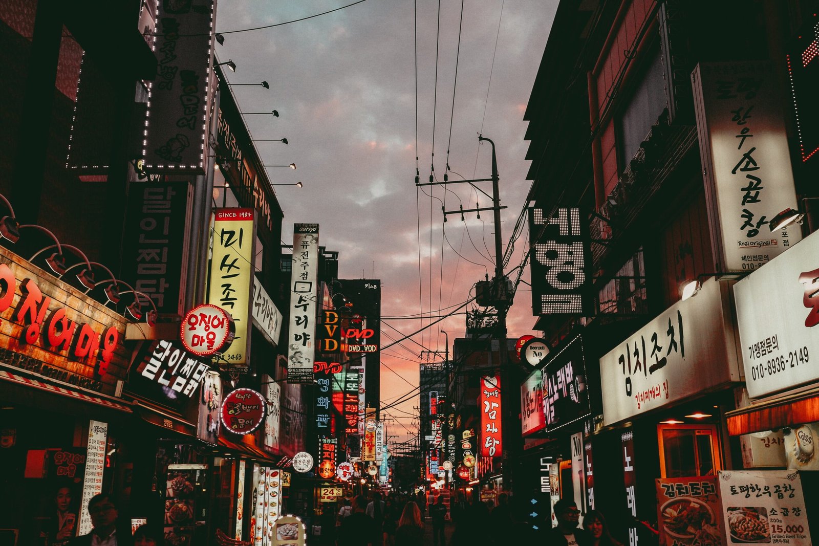 Picture of advertising along a crowded street in South Korea at night.